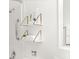 Bathroom detail featuring decorative shelves with plants and towels and a shower safety bar at 4215 E Bay Dr # 1806D, Clearwater, FL 33764