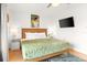 Bright bedroom with a ceiling fan, TV, and tropical decor, perfect for relaxing near the beach at 4215 E Bay Dr # 1806D, Clearwater, FL 33764