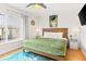 Bright bedroom with a plush bed, stylish decor, and natural light, creating a tranquil retreat at 4215 E Bay Dr # 1806D, Clearwater, FL 33764