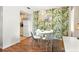 Dining area with leafy wallpaper, a modern table, and seamless access to the kitchen at 4215 E Bay Dr # 1806D, Clearwater, FL 33764