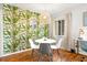 Bright dining area featuring tropical-themed wallpaper, a pendant light, and natural light at 4215 E Bay Dr # 1806D, Clearwater, FL 33764