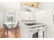 Modern kitchen view showcasing an electric range and an adjacent dining area with stylish pendant lighting at 4215 E Bay Dr # 1806D, Clearwater, FL 33764
