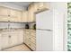 Well-lit kitchen with light-colored cabinets, granite countertops, and a stainless-steel refrigerator at 4215 E Bay Dr # 1806D, Clearwater, FL 33764