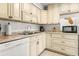 Cozy kitchen featuring cream cabinetry, stainless steel sink, granite countertops, and modern appliances at 4215 E Bay Dr # 1806D, Clearwater, FL 33764