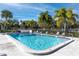 Refreshing community pool with lounge chairs and palm trees, offering a relaxing atmosphere at 4215 E Bay Dr # 1806D, Clearwater, FL 33764