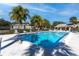 Community pool surrounded by lounge chairs and lush landscaping, perfect for relaxation and recreation at 4215 E Bay Dr # 1806D, Clearwater, FL 33764
