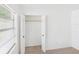 Bedroom showing a standard closet with bi-fold doors and a window providing natural light at 4937 Steel Dust Ln, Lutz, FL 33559