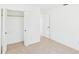 Neutral bedroom featuring carpet flooring, a closet, and a doorway to the rest of the house at 4937 Steel Dust Ln, Lutz, FL 33559