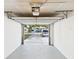 Clean, empty garage interior view highlighting the garage door opener and backyard view at 4937 Steel Dust Ln, Lutz, FL 33559