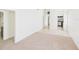 Bright living room with a blend of carpet and tiled flooring, leading into the kitchen at 4937 Steel Dust Ln, Lutz, FL 33559