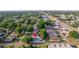 An aerial view displaying the home surrounded by lush greenery and other single-Gathering residences at 6328 S Harold Ave, Tampa, FL 33616