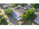 Aerial view of the property showcasing the home's layout, backyard with shed, and the surrounding neighborhood at 6328 S Harold Ave, Tampa, FL 33616