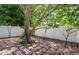 Backyard features a swing hanging from a tree with a privacy fence and brick patio at 6328 S Harold Ave, Tampa, FL 33616