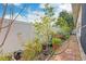 Backyard garden featuring a stone walkway, vibrant plants, and a white fence at 6328 S Harold Ave, Tampa, FL 33616