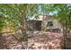 Landscaped backyard featuring a brick patio and view of screened-in patio and house at 6328 S Harold Ave, Tampa, FL 33616