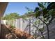Fenced in backyard features a narrow walkway with plants, rocks, and mulch at 6328 S Harold Ave, Tampa, FL 33616