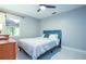 Cozy bedroom features a comfortable bed, ceiling fan and a bright window view at 6328 S Harold Ave, Tampa, FL 33616