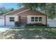 Charming single-Gathering home featuring a well-maintained lawn and inviting double-door entrance at 6328 S Harold Ave, Tampa, FL 33616