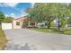 Charming single-story home with a well-maintained lawn, mature tree, and long driveway at 6328 S Harold Ave, Tampa, FL 33616
