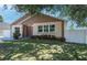 A welcoming single-story home featuring lush landscaping and a white privacy fence at 6328 S Harold Ave, Tampa, FL 33616