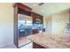 Modern kitchen features stainless steel refrigerator, granite countertops, and dark wood cabinets at 6328 S Harold Ave, Tampa, FL 33616