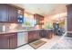 Well-equipped kitchen with stainless steel appliances, granite countertops, and stylish dark wood cabinetry at 6328 S Harold Ave, Tampa, FL 33616