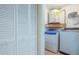 Practical laundry area with washer, dryer, storage and a water heater at 6328 S Harold Ave, Tampa, FL 33616