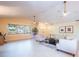 Comfortable living room with white furniture, tile flooring, and natural light from large windows at 6328 S Harold Ave, Tampa, FL 33616