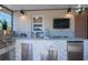 Outdoor kitchen area with stone detailing, a stainless steel grill and ample counterspace at 6328 S Harold Ave, Tampa, FL 33616