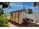 Backyard shed features a double door, window box, and brick patio with chairs at 6328 S Harold Ave, Tampa, FL 33616