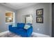 Comfortable sitting room with natural light, a vibrant blue sofa and decor at 6328 S Harold Ave, Tampa, FL 33616