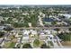 An aerial view of the neighborhood featuring mature trees, lush landscaping, and a peaceful pond at 8431 52Nd N Way, Pinellas Park, FL 33781