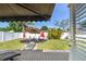 The backyard features an awning, patio furniture, shade umbrellas, and a white privacy fence at 8431 52Nd N Way, Pinellas Park, FL 33781