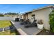 A wood deck with a bar and lounge chairs sits in a backyard with a white privacy fence at 8431 52Nd N Way, Pinellas Park, FL 33781