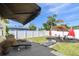 Backyard featuring a wood deck, black lounge chairs, shade umbrellas and a white privacy fence at 8431 52Nd N Way, Pinellas Park, FL 33781