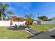 The backyard features an outdoor seating area, a storage shed and a well manicured lawn at 8431 52Nd N Way, Pinellas Park, FL 33781