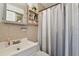 Bathroom featuring a white vanity, wall shelves, and a shower with a patterned gray curtain at 8431 52Nd N Way, Pinellas Park, FL 33781