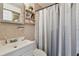 Bathroom featuring tiled walls, a sink, and a shower at 8431 52Nd N Way, Pinellas Park, FL 33781