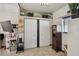 Bedroom features double door closet, tiled floors, a TV, and is decorated with wall art at 8431 52Nd N Way, Pinellas Park, FL 33781