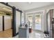 This kitchen opens to an office space with sliding barn door and backyard access through bright, natural light at 8431 52Nd N Way, Pinellas Park, FL 33781