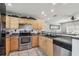 Kitchen features stainless steel appliances, a mirrored backsplash, and warm wood cabinets for a charming design at 8431 52Nd N Way, Pinellas Park, FL 33781