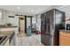 Kitchen with stainless steel refrigerator, office space, and access to the backyard via a sliding barn door at 8431 52Nd N Way, Pinellas Park, FL 33781
