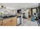 Open kitchen featuring a double sink, stainless steel dishwasher, and view of the living area beyond the breakfast bar at 8431 52Nd N Way, Pinellas Park, FL 33781
