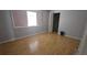 This bedroom features wood floors, a large window for natural light and ample closet space at 8623 Stonehedge Way, Hudson, FL 34667