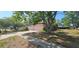 Charming single-story house with lush trees, front yard and a driveway in a residential area at 8623 Stonehedge Way, Hudson, FL 34667