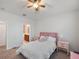 Cozy bedroom featuring soft carpet, a ceiling fan, and an ensuite bathroom at 956 Sombra St, Tampa, FL 33619