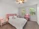 Bright bedroom with neutral walls, plush carpet, and pink accents at 956 Sombra St, Tampa, FL 33619