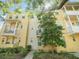 Inviting multi-story townhome featuring balconies and lush landscaping, offering a blend of comfort and curb appeal at 956 Sombra St, Tampa, FL 33619