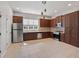 Bright kitchen featuring dark wood cabinets, stainless steel appliances, tile backsplash, and a spacious layout at 956 Sombra St, Tampa, FL 33619