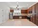 Well-equipped kitchen with dark wood cabinets, stainless steel appliances, tile backsplash, and ample counter space at 956 Sombra St, Tampa, FL 33619